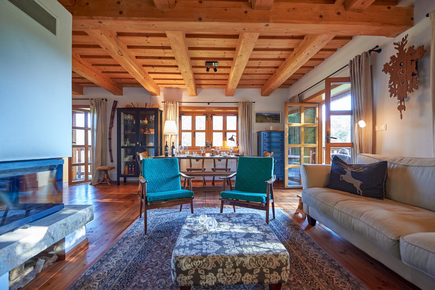 Living room of Lubka Lodge with fireplace and warm wood interior